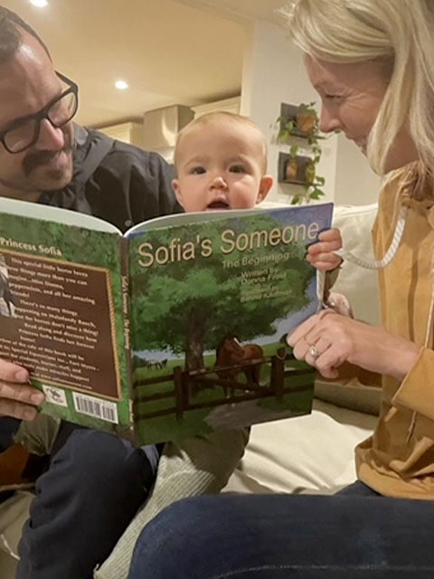 Baby Reading a Picture Book About Horses